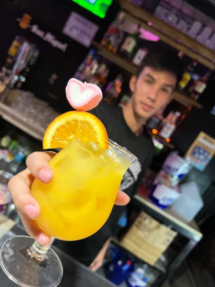 Bartender serving af cocktail at Marbeach Rooftop Bar