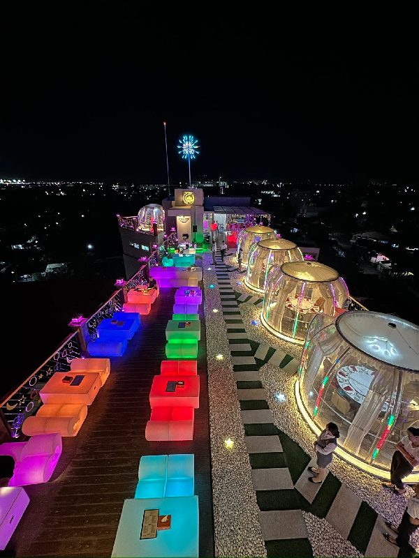 A rooftop seen from above with illuminated seatings