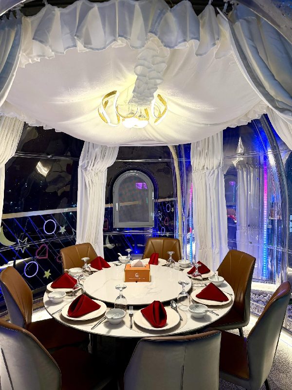 Inside a dining dome with a round table and seatings