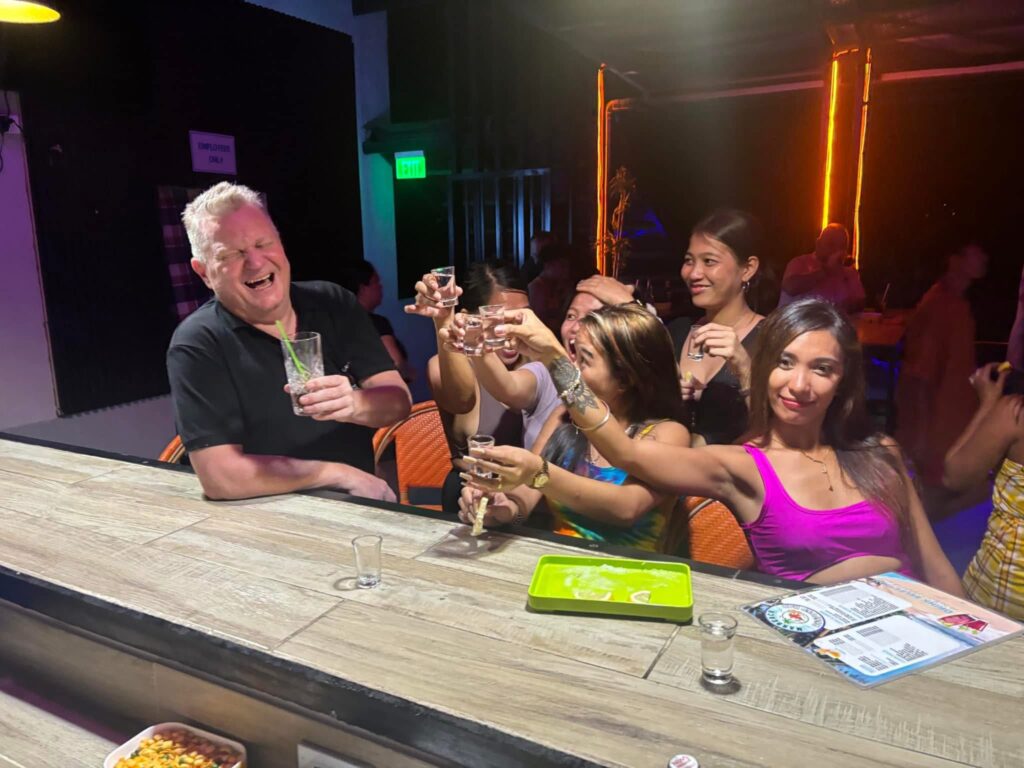 Customer and staff enjoying a good evening at a bar